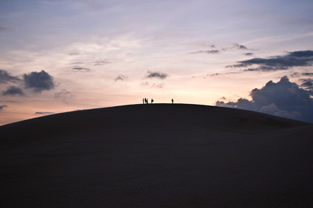 Silhouettes of people on a sky backgroundの写真素材