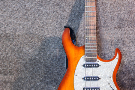 white and orange electric guitar on the black background