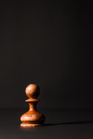 chess pieces made out of wood on a black backgroundの写真素材