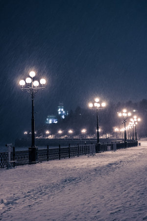 burning lanterns of the evening embankment of the Amur River in Khabarovsk