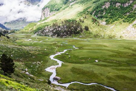 Alpine meadows and rocks in the Caucasus mountains in Russiaの写真素材