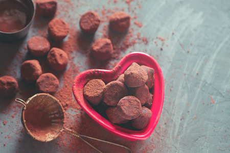 Chocolate truffles in a heart shaped bowlの写真素材