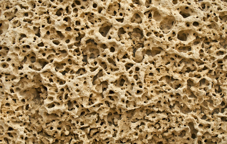 Textured background of pitted stone surface. Excavation of ancient Caesarea. It was constructed by the King Herod the Great.の写真素材