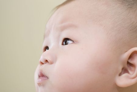 confused looking asian babyの写真素材