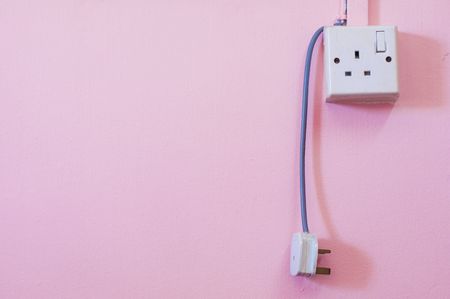 asian type electrical power outlet with pink wallの写真素材