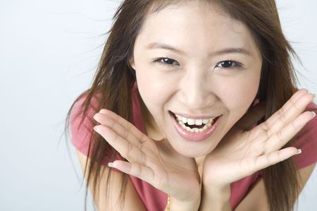 shocked smile happy looking asian girlの写真素材
