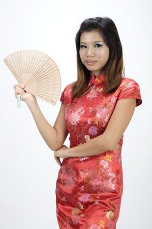 chinese girl in cheongsam and fanの写真素材