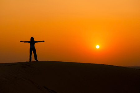 silhouette of a freedom girl on thar sam sand dune desertの写真素材