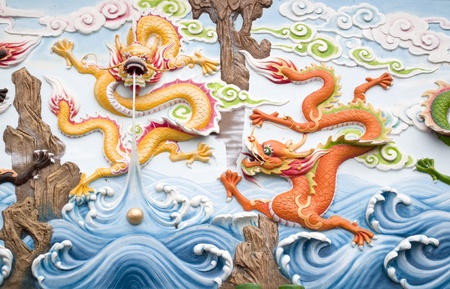 dragon statues on wall of a beautiful templeの写真素材
