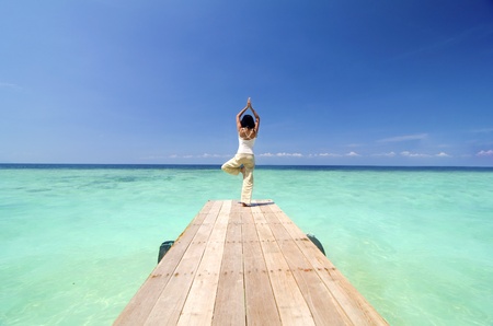 asian yogo on beautiful beach ,standing poseの写真素材
