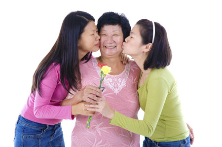 Daughters kissing to her mum.