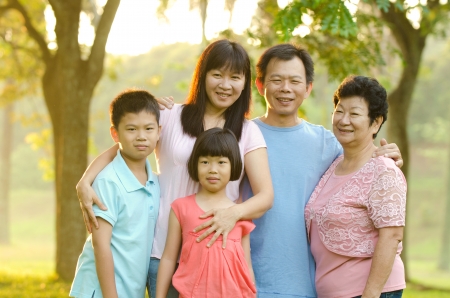 Extended family standing outdoors smilingの写真素材