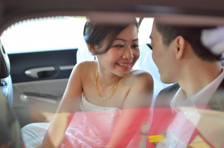 asian wedding couple candid shot during their actual day wedding ,focus on bride's eyesの写真素材
