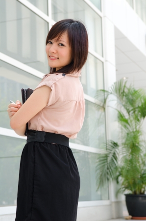 chinese female student in formal wear, shot from backの写真素材