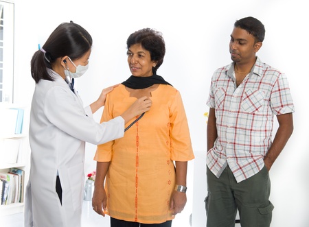 indian senior medical checkup with an asian female doctorの写真素材