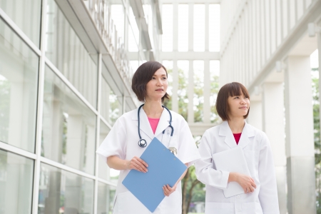 asian medical doctors looking at somewhereの写真素材