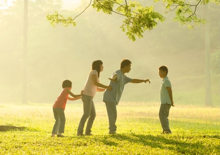  happy asian family playing having quality time at outdoor green  parkの写真素材