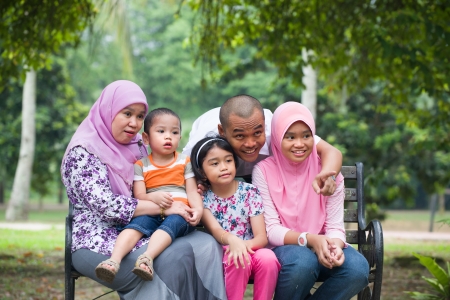 Happy Malay Asian Family enjoying family time together in the park

の写真素材