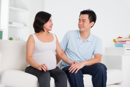 asian pregnant mother and her husbandの写真素材