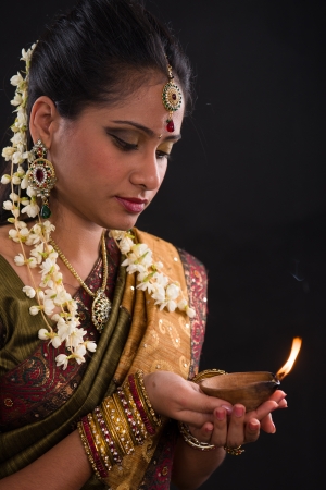 traditional indian woman with oil lamp during the celebration of deepawali or diwaliの写真素材