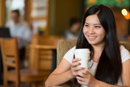 asian girl enjoying coffee in the morning lifestyle photoの写真素材