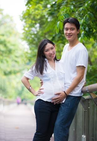 Happy young pregnant asian couple in the nature

の写真素材