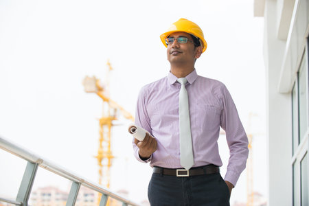 indian male architect with construction 
