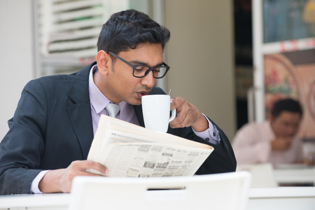 young indian business man on laptop and coffee at a cafe

の写真素材