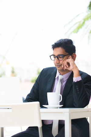 young indian business man on laptop and coffee at a cafe

の写真素材