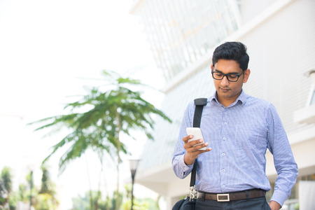 indian business man reading or using smart phone

の写真素材
