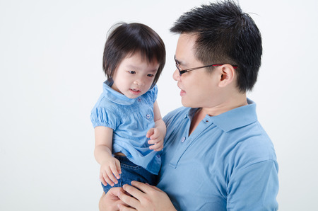 asian father and daughter on plain backgroundの写真素材