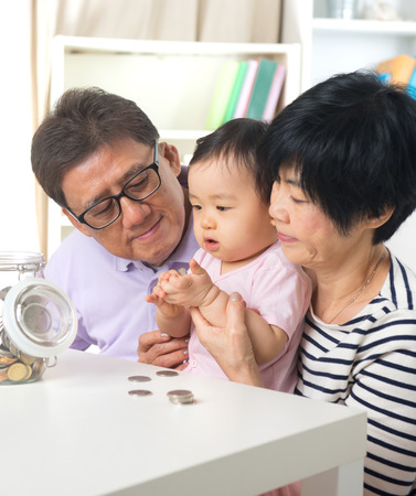 asian grand parents with grand daugther education saving concepts asian grand parents with grand daugther education saving concepts
