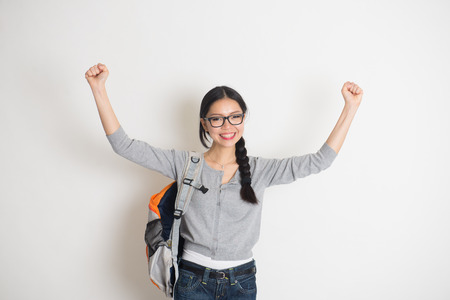 asian college girl celebrating success in joyの写真素材