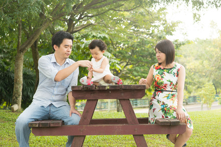 Happy Asian Family enjoying their time in the parkの写真素材