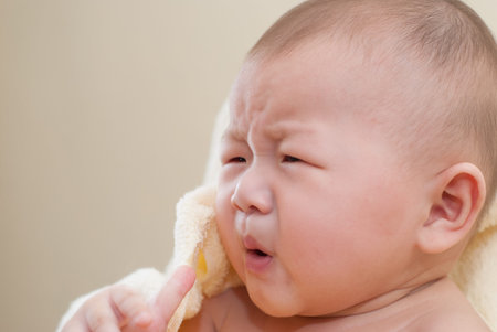 A cute little asian baby with surprise expression.の写真素材