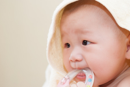 asian baby biting toysの写真素材
