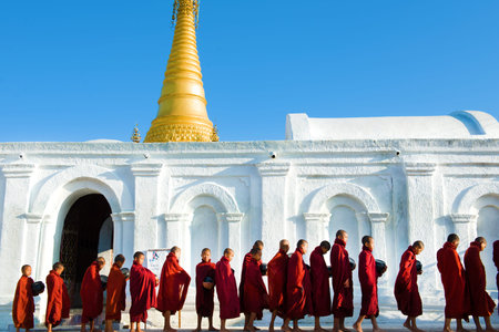 INLE LAKE, MYANMAR - JULY 10 : Buddhist novices walk to collect alms and offerings on JULY 10,2015...