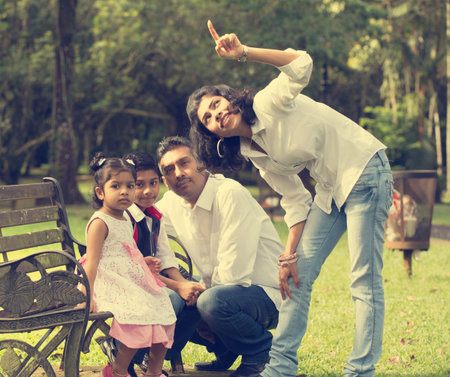 indian family enjoying quality time at outdoor parkの写真素材