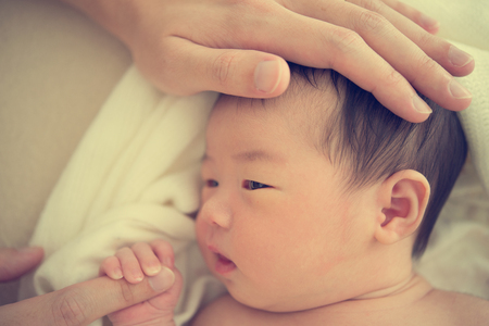 asian newborn on bedの写真素材