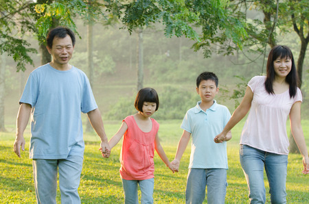 Happy Asian family walkingの写真素材