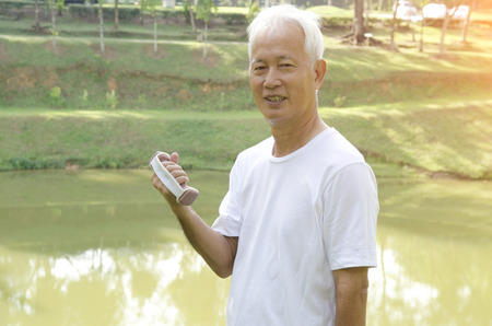 asian senior outdoor dumbellの写真素材