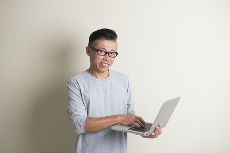 asian casual senior with laptopの写真素材