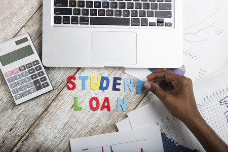 Hand arrange wood letters as student Loan wordの写真素材