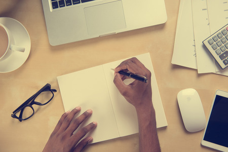 hand working with work space concept in vintage toneの写真素材