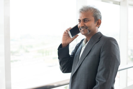 matured indian business male on phone conversation