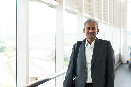 matured indian business male walking at airportの写真素材