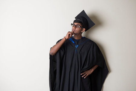 indian male graudate thinkingの写真素材