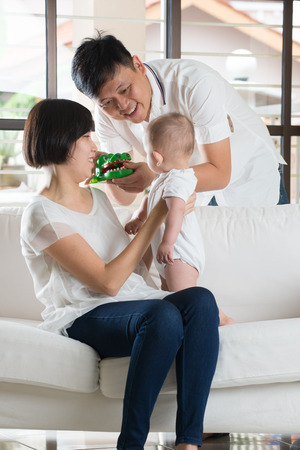 asian parent playing with babyの写真素材