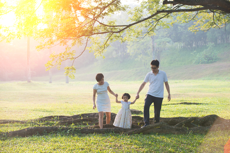 Happy Asian Family enjoying family time together in the park

の写真素材
