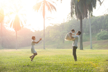 Happy Asian Family enjoying family time together in the park

の写真素材